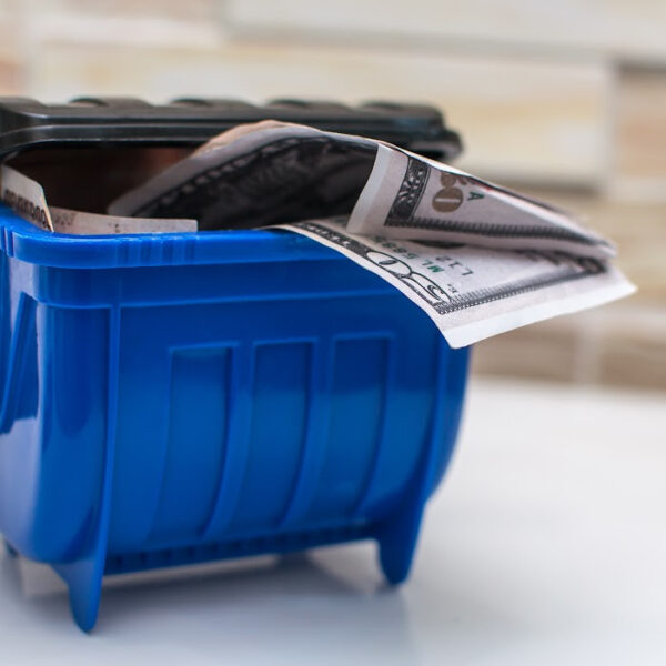 a miniature dumpster filled with money